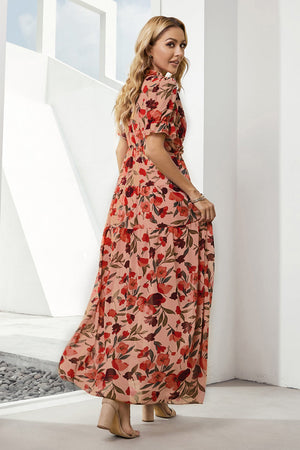 Tiered floral maxi dress in blush with puff sleeves and a flowing skirt.