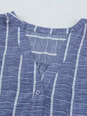 Dusty blue striped V-neck buttoned blouse with a textured fabric.
