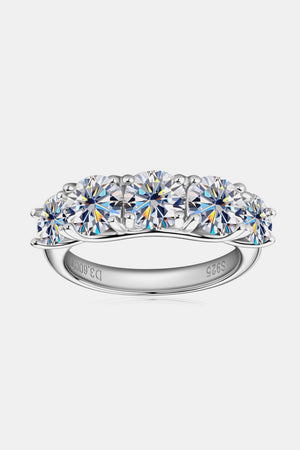 Silver five-stone moissanite eternity band ring with round brilliant cut stones.