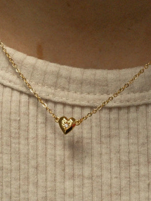 Gold heart pendant necklace with diamond accent on delicate chain
