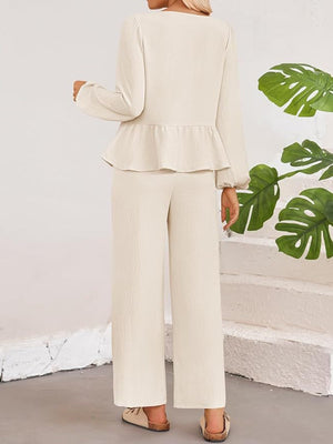 Cream textured peplum tie-neck co-ord set with wide leg pants and balloon sleeves.