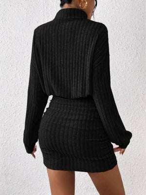 Black ribbed turtleneck mini dress with long sleeves and a bodycon fit.