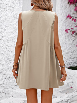 Sand trapeze mini dress with seam detail and tiered skirt.