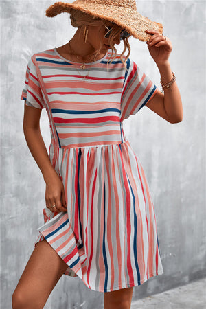 Striped trapeze dress with short sleeves and a yoke seam in coral, navy, and grey stripes.