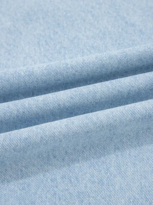 Light wash denim fabric detail, showing texture and weave of wide-leg jeans.