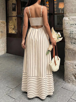 Patterned cutout maxi dress with smocked detail, featuring vertical stripes and a tiered hem.