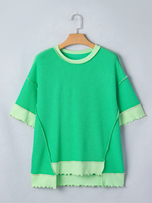 Twist ribbed t-shirt in bright green with contrast stitching and asymmetrical hem.