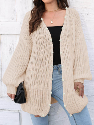 Tan knit cardigan with balloon sleeves and pearl buttons, open front, casual style.