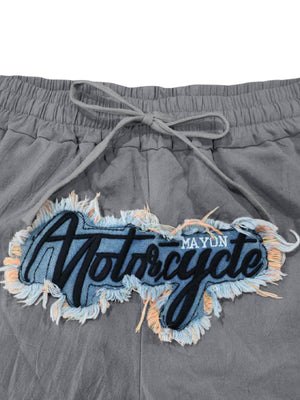 Grey sweatpants with drawstring and distressed motorcycle graphic patch
