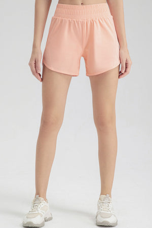 Layered performance running shorts in watermelon pink with elastic waistband and curved hem.