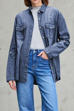 Relaxed light blue denim shirt with patch pockets and button front, styled casually.