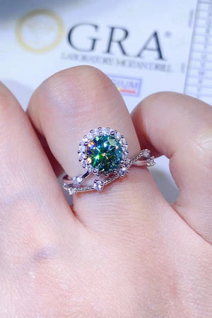 Light green diamond halo ring with white diamond accents on a delicate band.