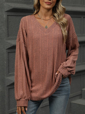 Textured ribbed v-neck blouse in rust with blouson sleeves and a relaxed fit.