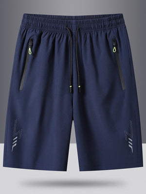 Men's blue drawstring athletic shorts with zippered pockets and reflective detail.