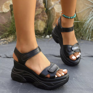 Black open-toe sandals with chunky block heel and adjustable straps, featuring "FASHION" detail.