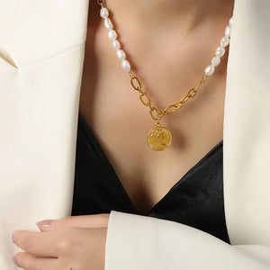 Gold pearl and coin link necklace with baroque pearls and a coin pendant.