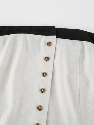 Button front tube maxi dress in beige cotton blend with tortoiseshell buttons and black trim.