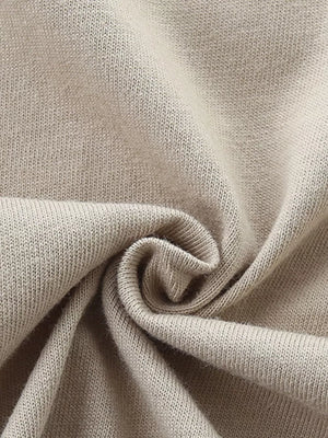 Close-up of beige cotton knit fabric with soft texture.
