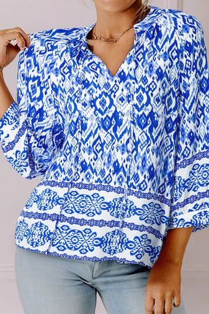Royal blue ikat print v-neck blouse with tie detail and border trim