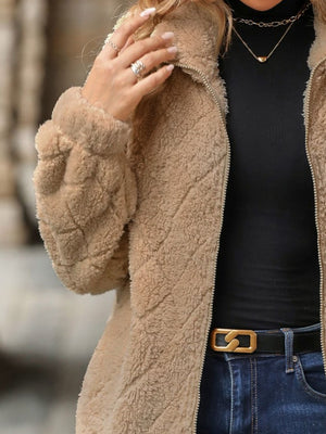 Tan textured teddy zip-up jacket with chevron quilting detail on sleeve.