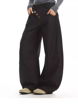 Black wide-leg chinos with decorative button-fly detail and relaxed fit.