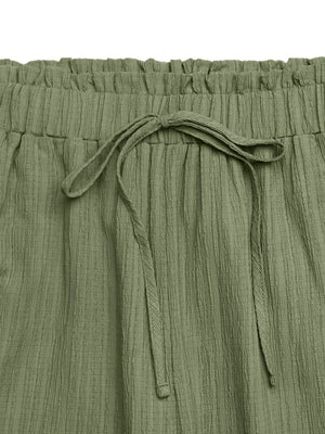 Crinkled olive green maternity pants with drawstring waist and wide legs.
