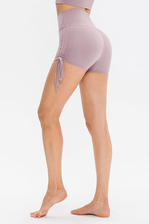 Lavender ruched-side active shorts with drawstrings and high waist.