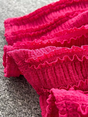 Textured rose red two-piece set with ruffled details and smocked fabric.