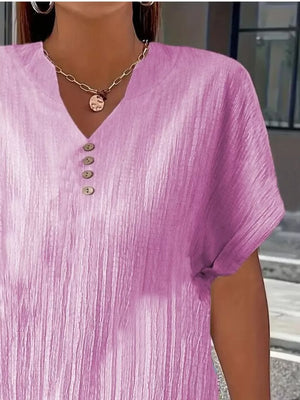 Textured light purple v-neck t-shirt with decorative buttons and short sleeves.