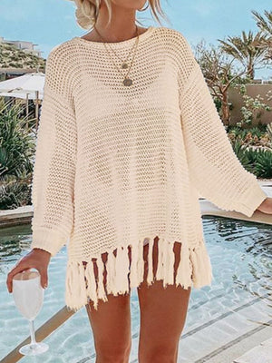 Cream open-knit acrylic beach cover-up with fringe hem and long sleeves.