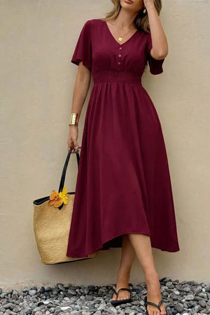 Burgundy V-neck midi dress with flutter sleeves, smocked waist, and button detail.