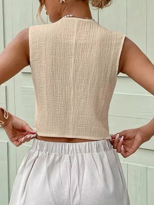 Apricot textured cotton cropped vest with button detail.