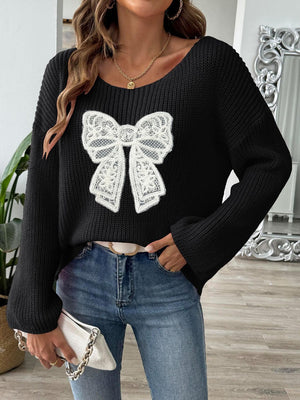 Black knit sweater with white lace bow detail and boatneck.