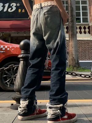 Two-tone distressed loose fit jeans with heavy fraying at the hems.
