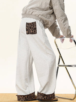Men's gray sweatpants with leopard print trim on pocket and cuffs.