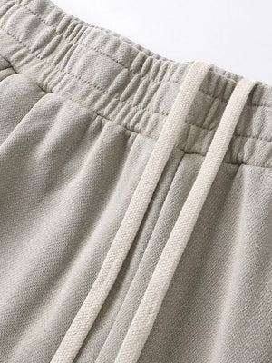 Light gray drawstring wide leg sweatpants with elastic waistband detail.