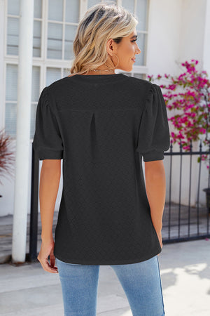 Black eyelet V-neck blouse with puff sleeves and a subtle diamond pattern.
