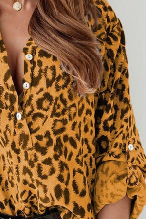 Mustard leopard print henley blouse with button front and rolled sleeves.