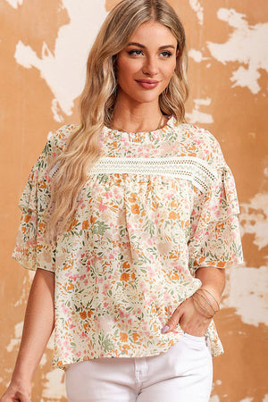 Floral ruffle trim blouse with keyhole neckline and short sleeves.
