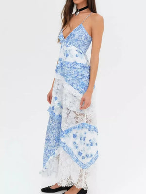 Blue floral lace maxi dress with asymmetrical ruffles and a V-neck.