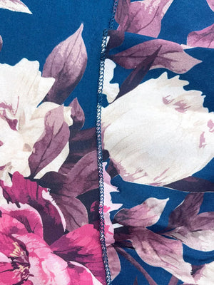 Ruffled floral two-piece set in French blue polyester with pink and white flowers.