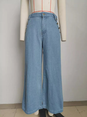 Light wash denim wide-leg pants with button details on the sides and front.