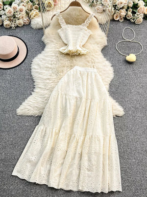 White eyelet maxi skirt and ruffled crop top set with elastic waistband.