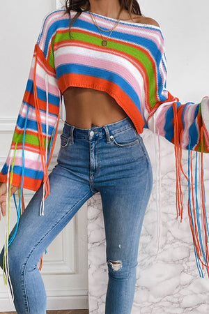 Cropped knit sweater with multicolor stripes and fringe sleeves, off-the-shoulder neckline.