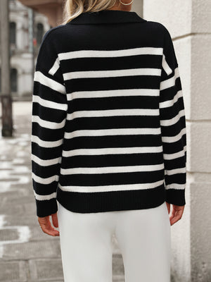 Black and white striped knit polo neck sweater with long sleeves.