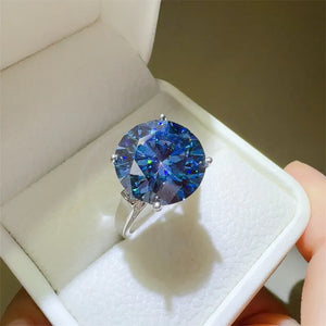 Celestial Azure Moissanite Statement Ring in silver with a large round blue stone in a white ring box.