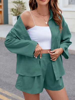 Teal pleated shorts and oversized button-down shirt set with a white crop top.
