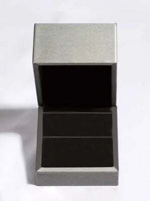 Prismatic Teal Statement Ring presentation box open, showing dark interior.