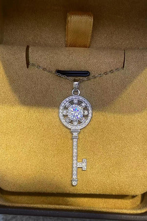Silver key pendant necklace with floral detail and sparkling stones