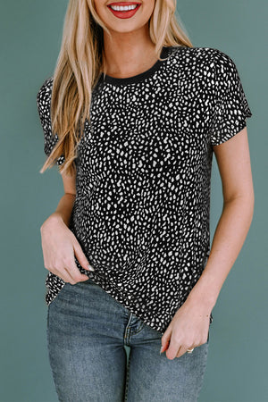 Black spotted print crew neck t-shirt with short sleeves, styled with blue jeans.
